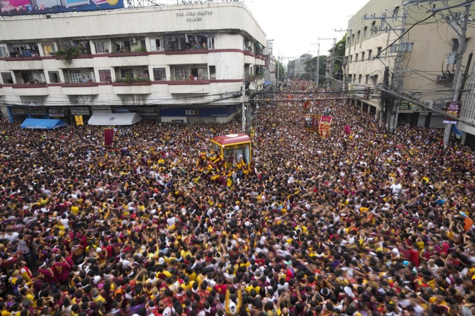 Philippine catholics swarm christ icon in feverish parade