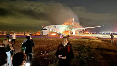 Japan airlines plane on fire on runway at tokyo s haneda airport tv images