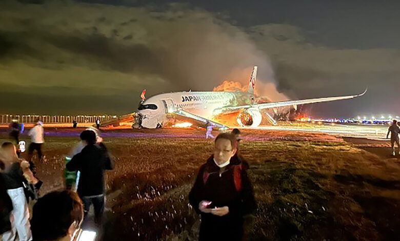 Japan airlines plane on fire on runway at tokyo s haneda airport tv images