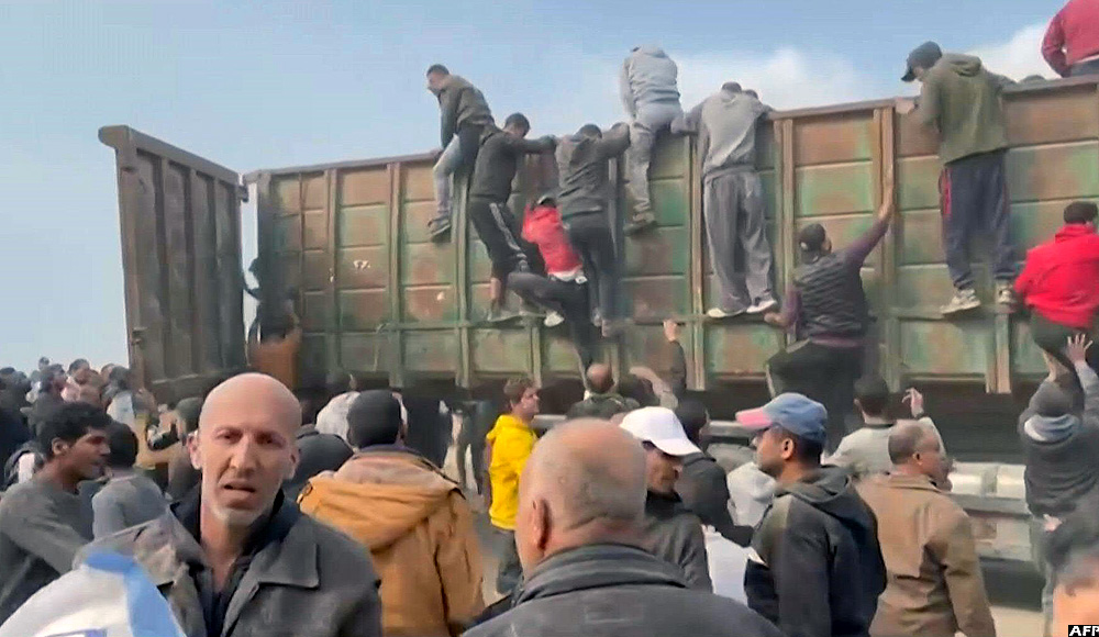 Gazans rush towards aid trucks carrying flour and canned food in gaza city