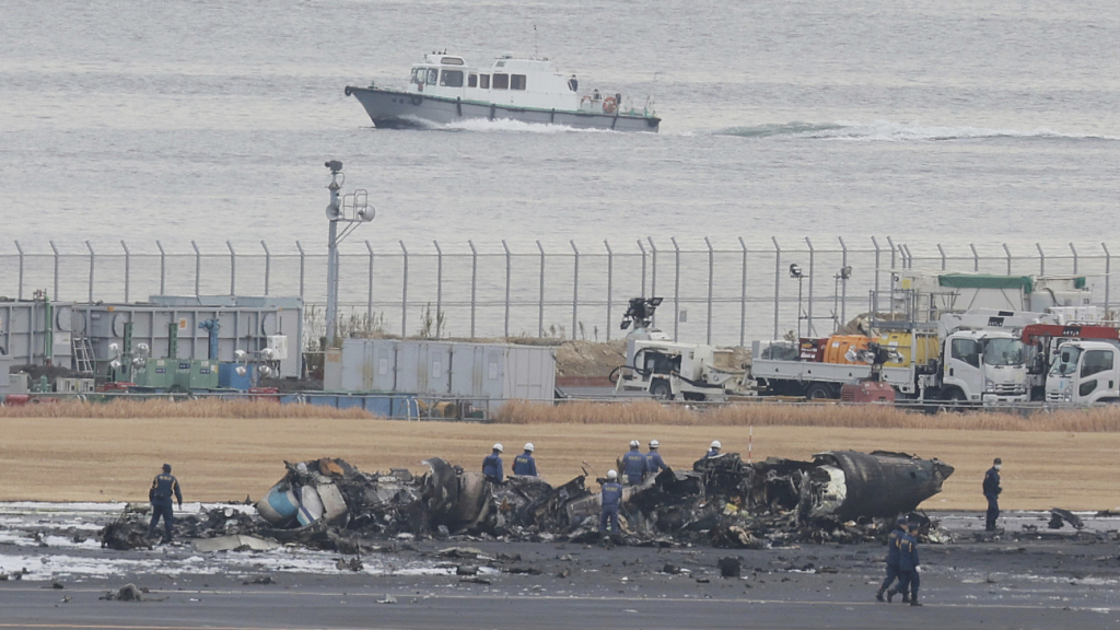 Japanese airliner burns after apparent collision with coast guard aircraft at tokyo s haneda airport