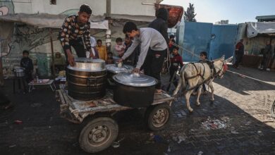 Gazans rush towards aid trucks carrying flour and canned food in gaza city