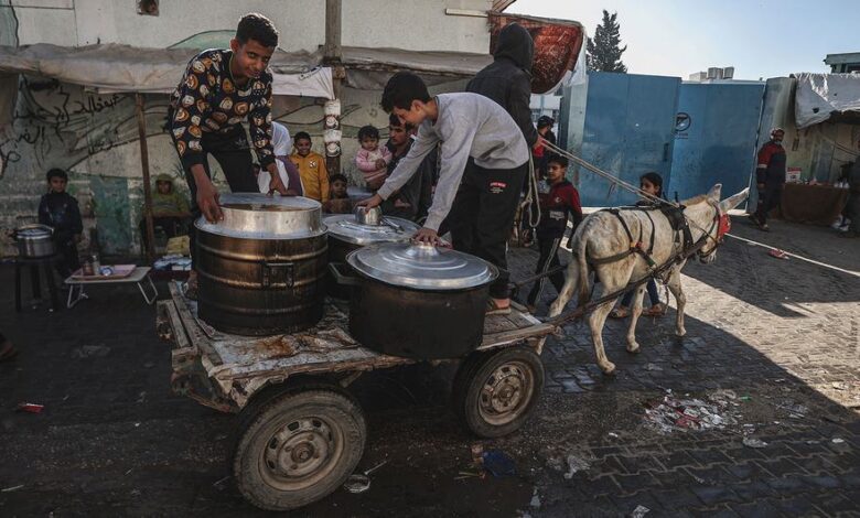 Gazans rush towards aid trucks carrying flour and canned food in gaza city