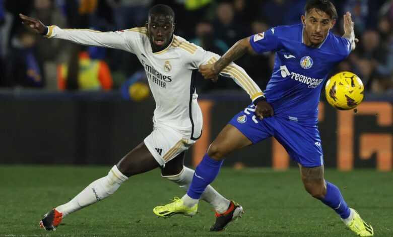 Joselu double sends madrid top at getafe