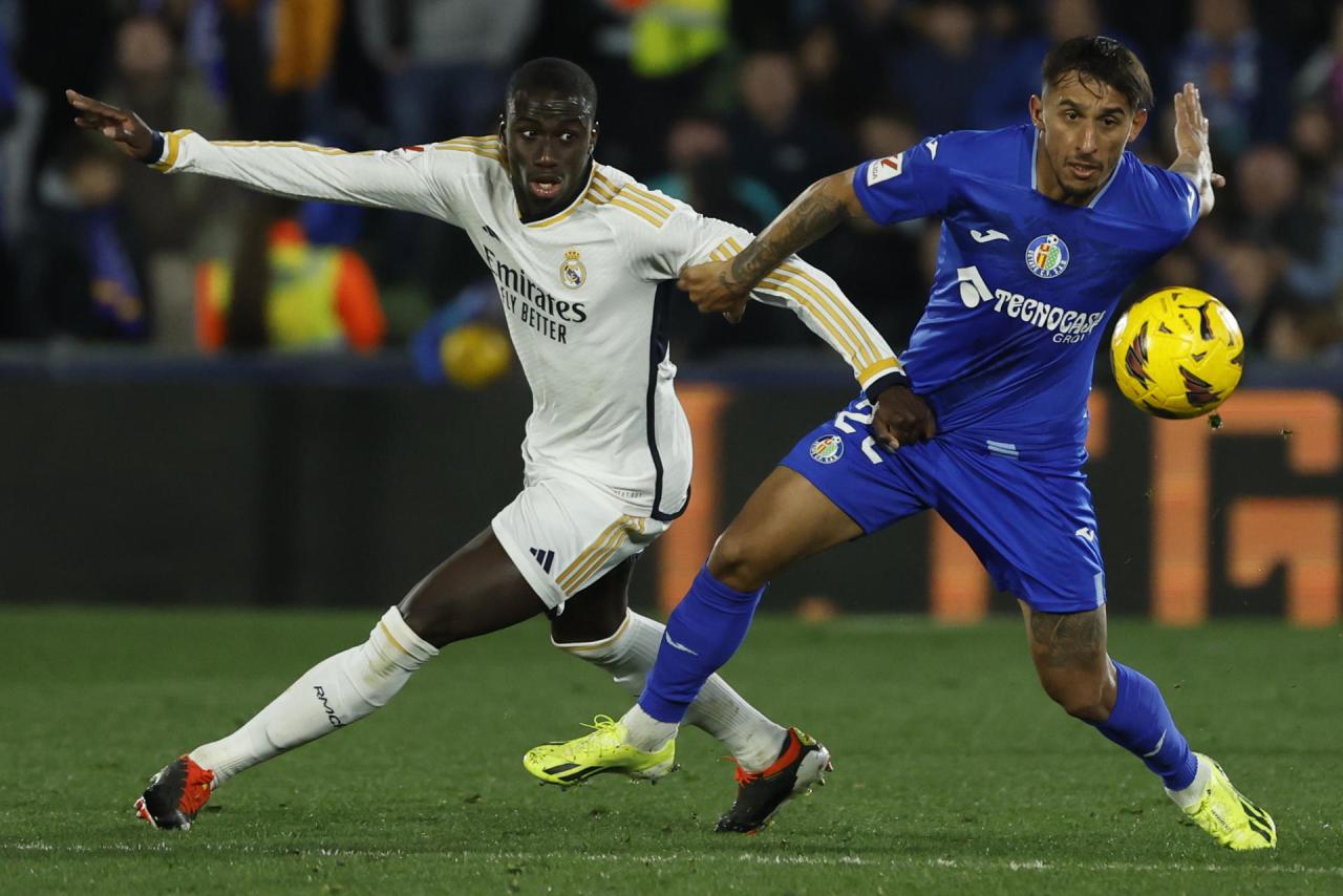 Joselu double sends madrid top at getafe